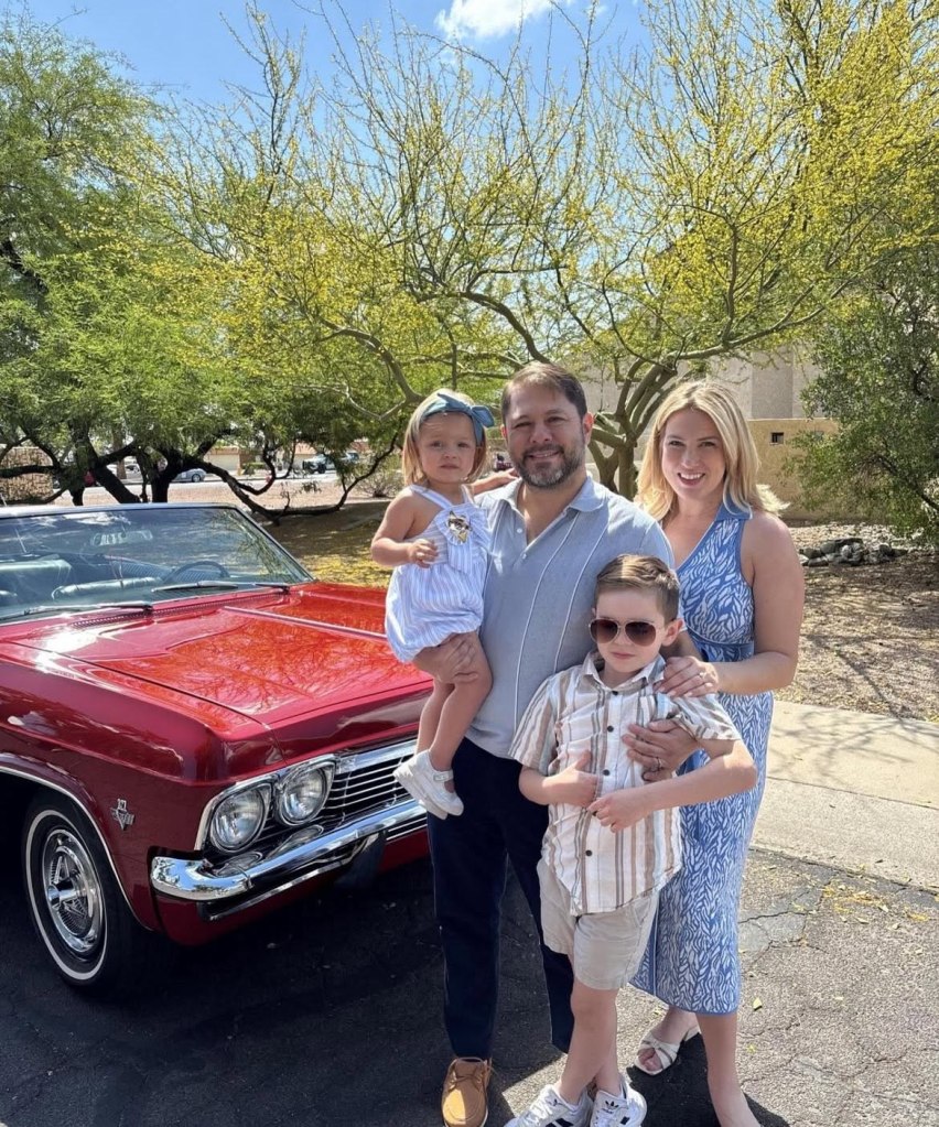 AZ Senator Ruben Gallego, his wife Sydney, daughter Isla, and son Cooper, stand in front of a red 1965 Chevy Impala.