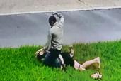 An image collage containing 1 images, Image 1 shows A blurry image of Pastor Tony Spell sitting on top of a person lying on the grass, with his arm raised as if to strike them
